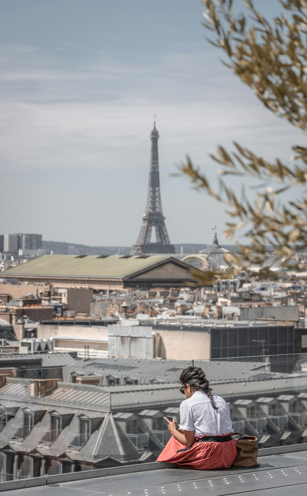 woman in black jacket sitting on the roof top during daytime