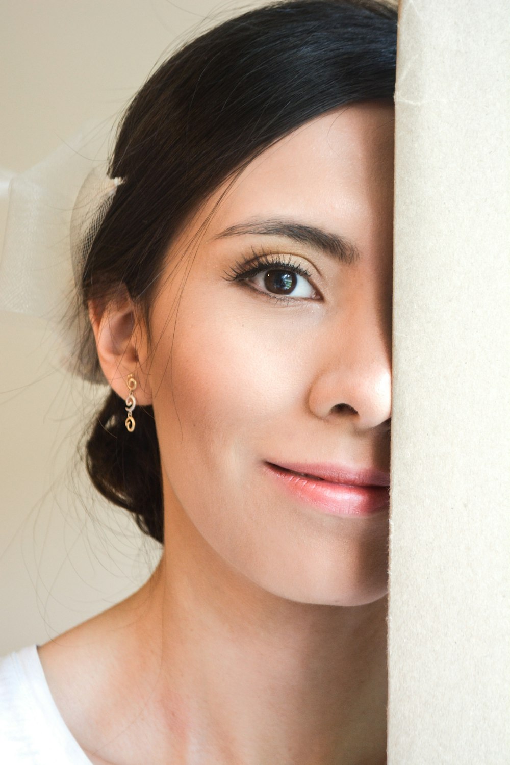 woman in white and gold earrings