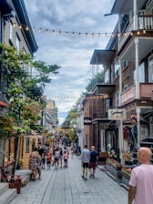 A vibrant street in Reus with various small businesses and happy customers.