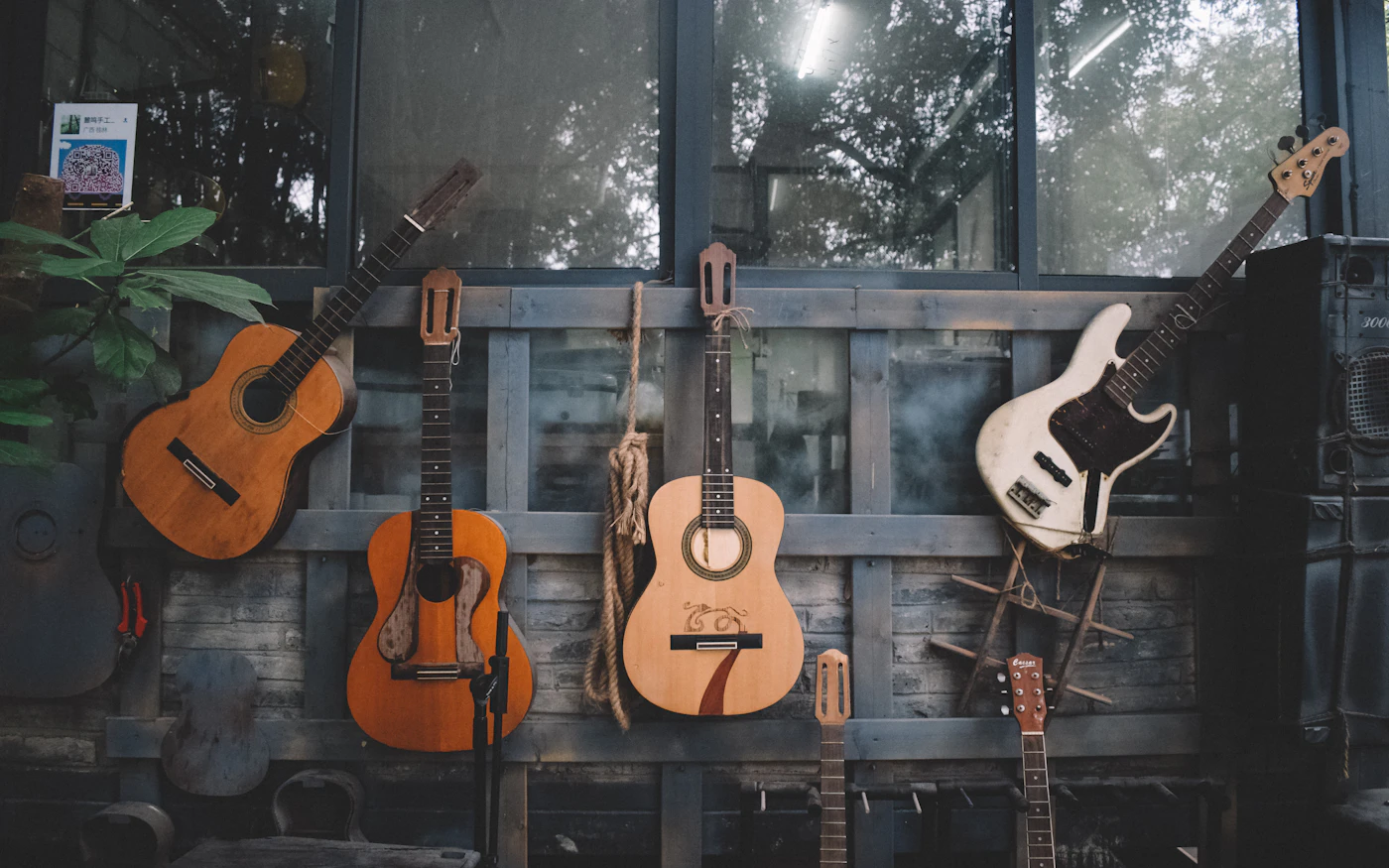 Acoustic and electric guitars hanging together on a wall