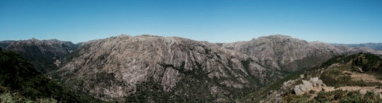 brown rocky mountain under blue sky during daytime in Gerês Portugal