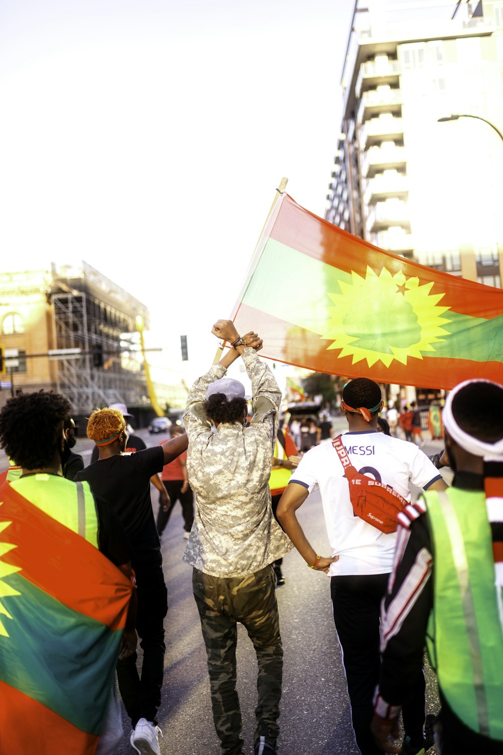 people walking on street with flags during daytime