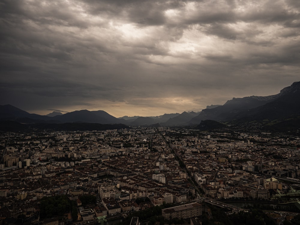 city with high rise buildings under gray sky