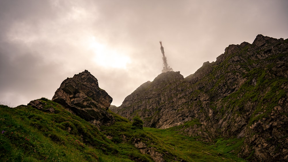 green grass covered mountain under white sky during daytime