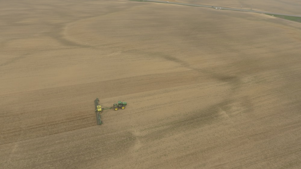 green and black plastic toy on brown sand