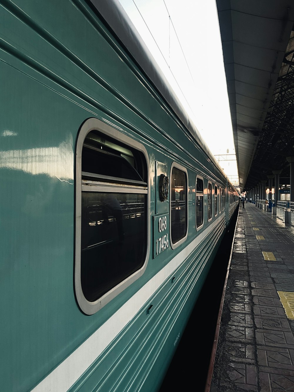 green and white train in train station