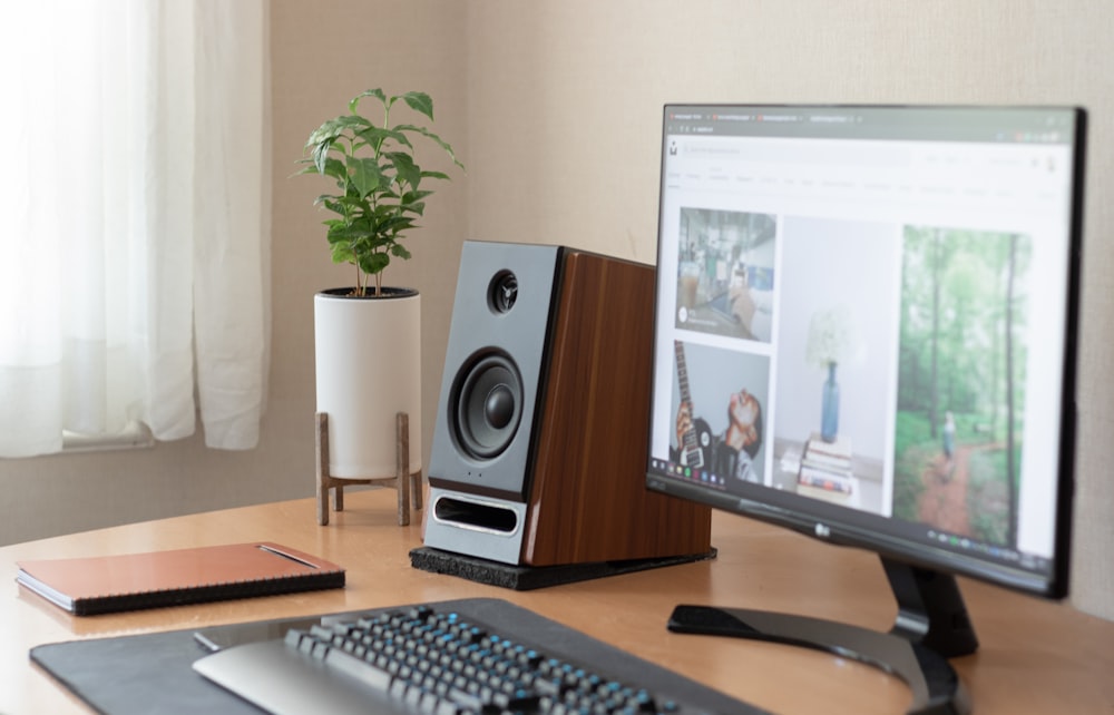 black computer keyboard beside black flat screen computer monitor