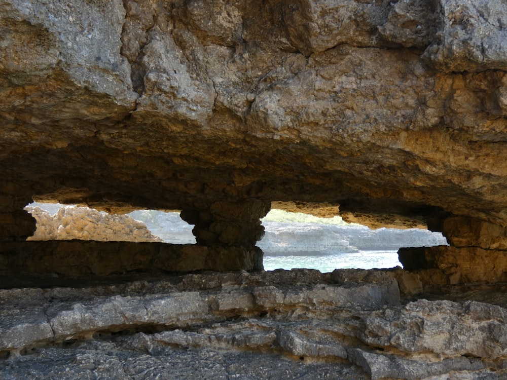 brown rock formation near body of water during daytime