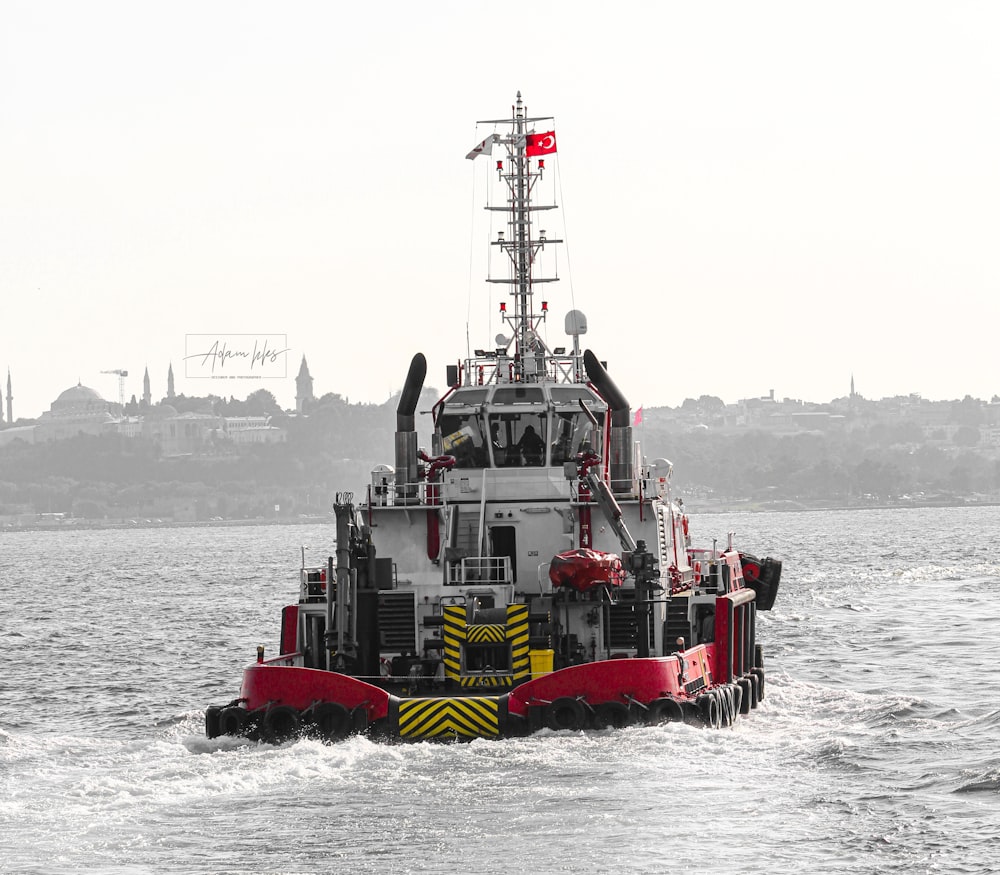 red and white ship on sea during daytime