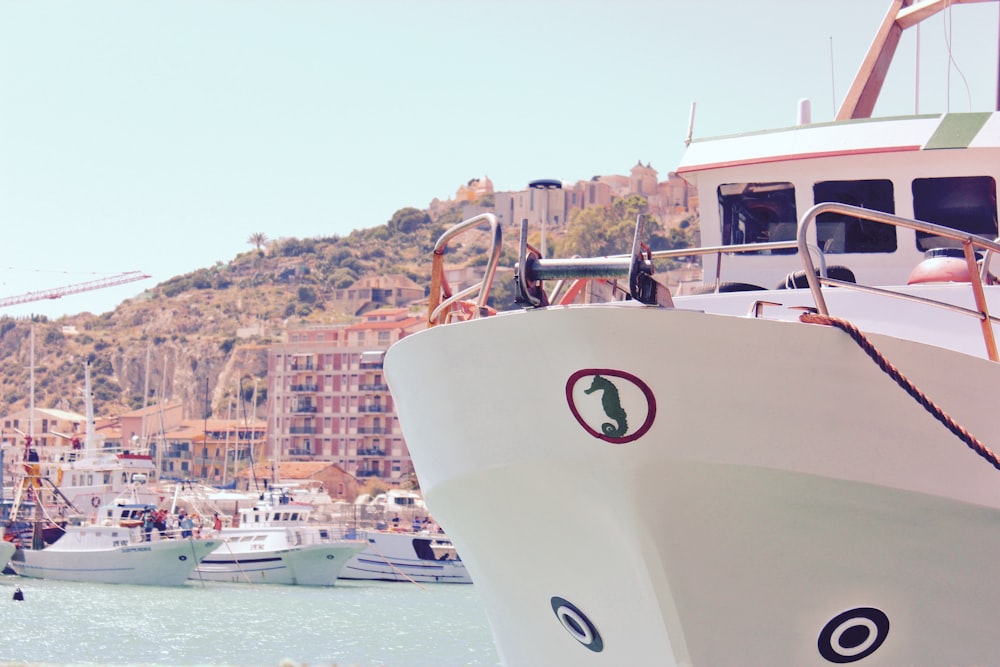 people riding on white boat on sea during daytime