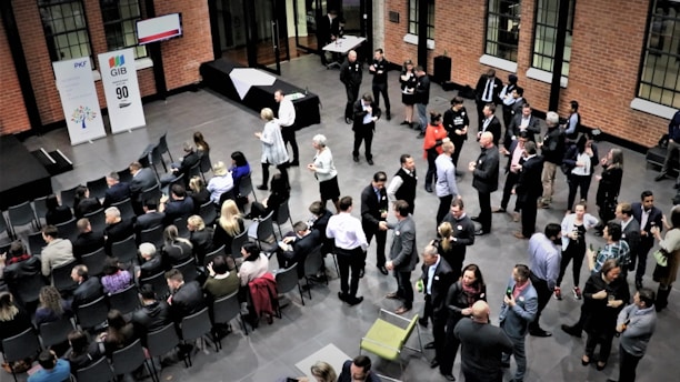 A lively event scene showing attentive staff coordinating a corporate gathering with professionalism.