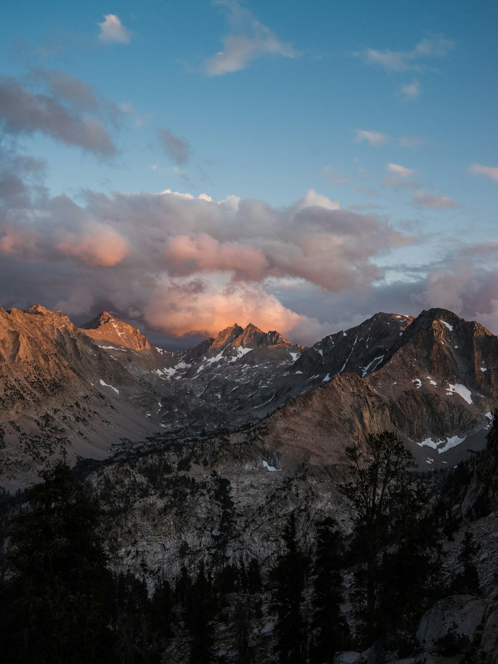 snow covered mountains under cloudy sky during daytime