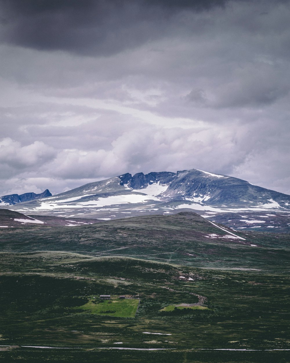 snow covered mountain under cloudy sky during daytime