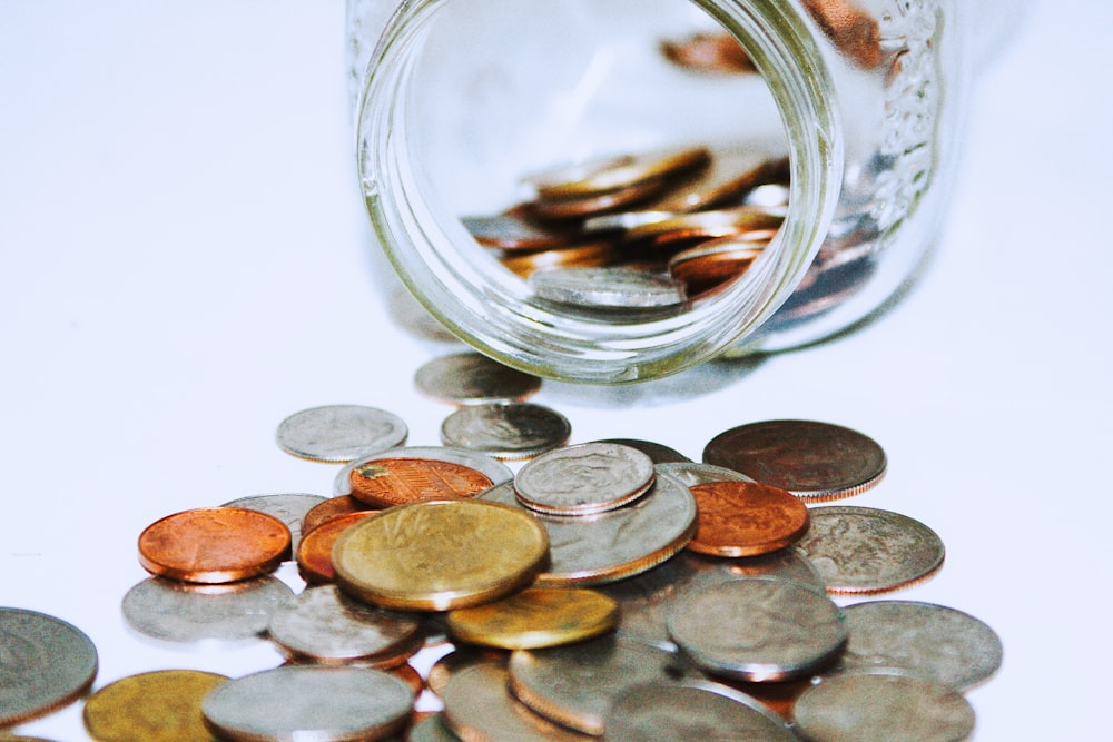 clear glass jar with coins