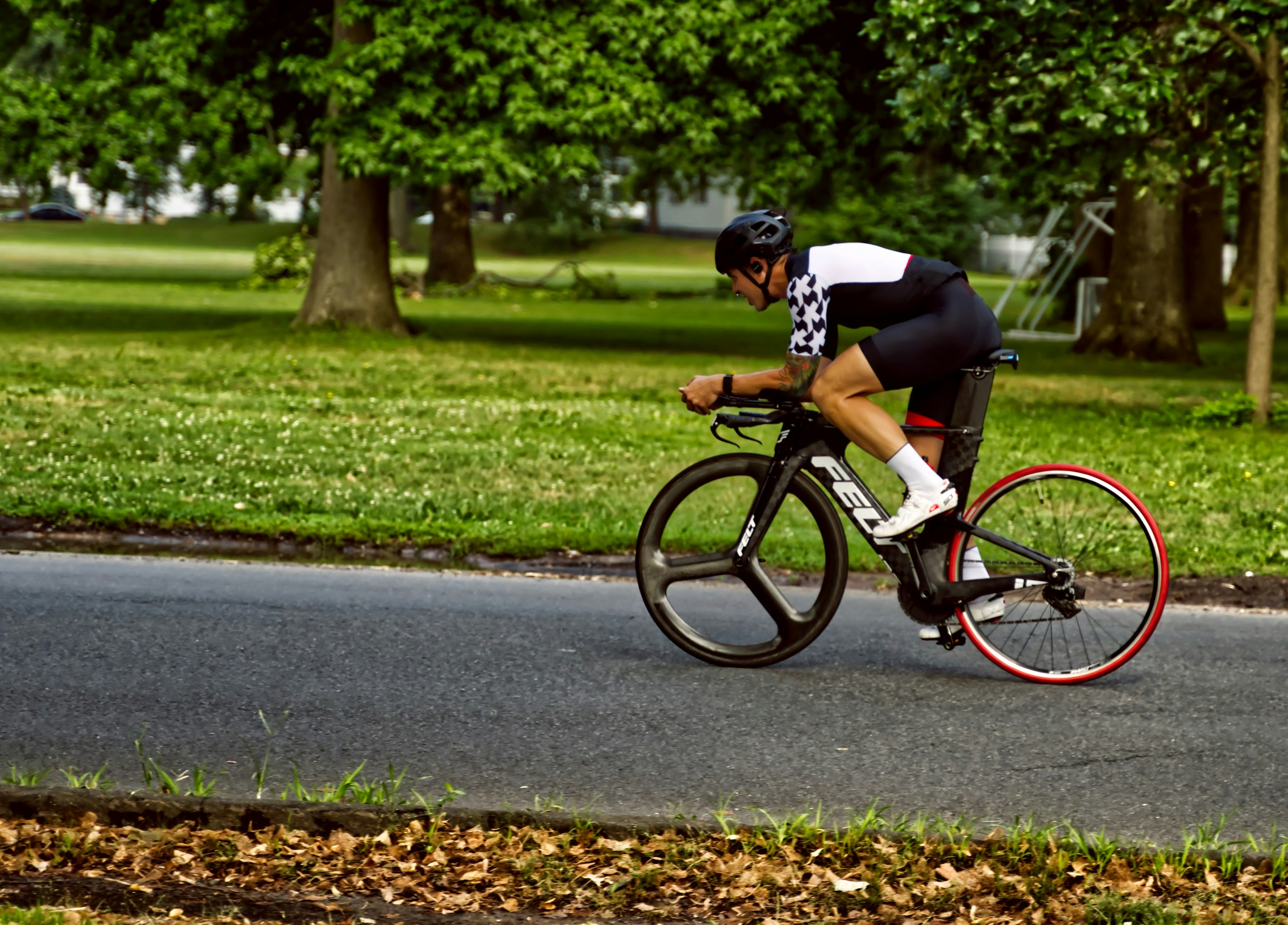 man in black shirt riding bicycle on road during daytime