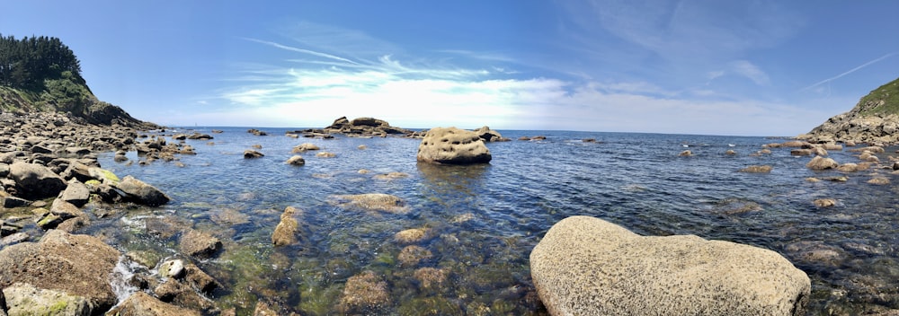 brown rock on body of water during daytime