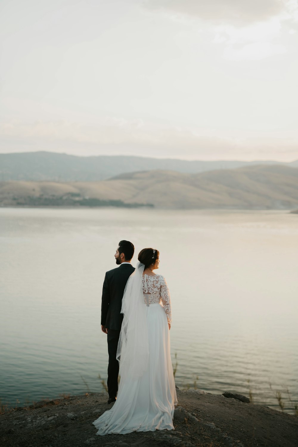 couple standing on the beach during daytime