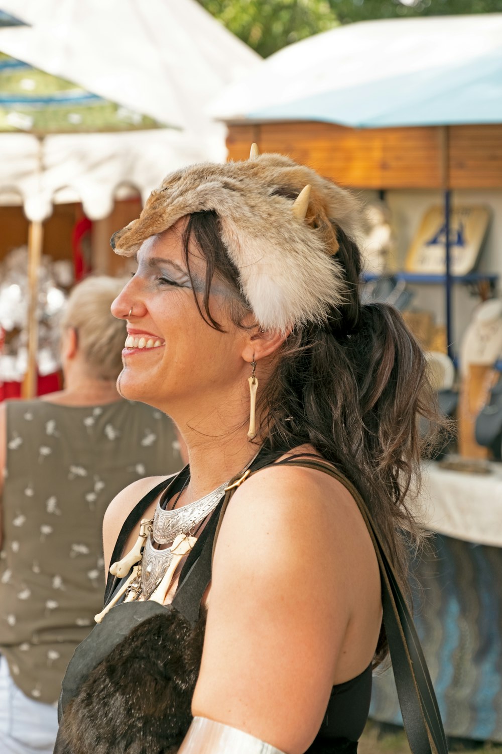 woman in black tank top wearing brown fur hat