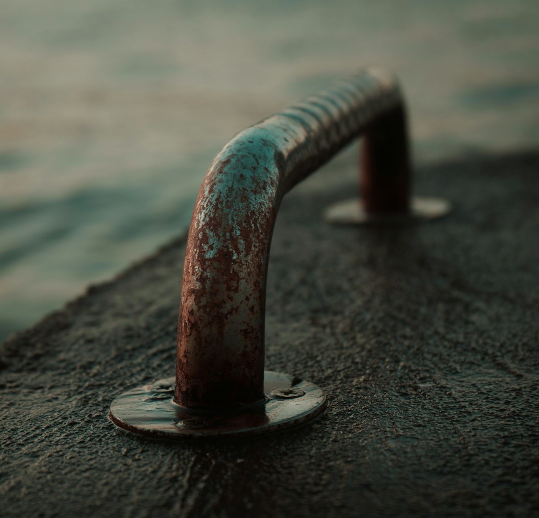 red metal pipe on grey concrete floor