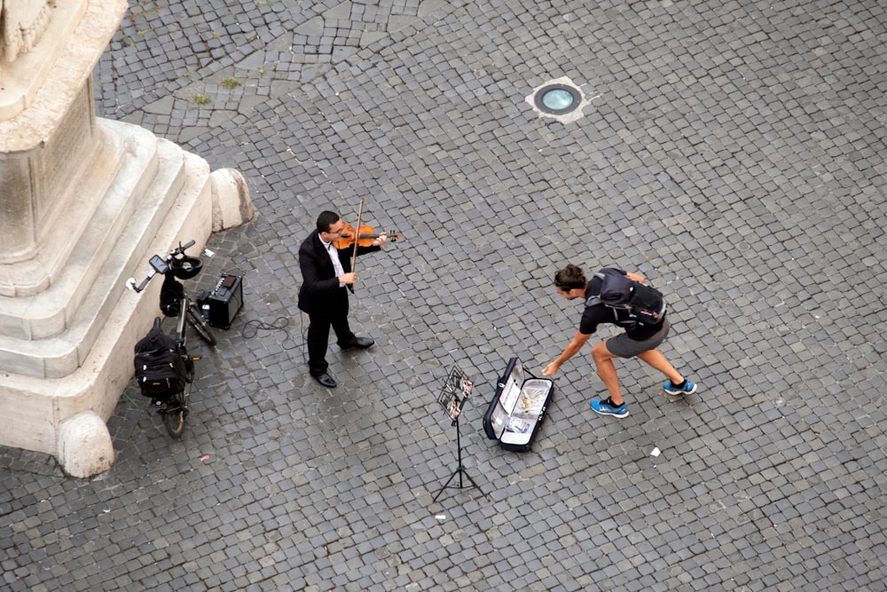 man in black t-shirt playing violin