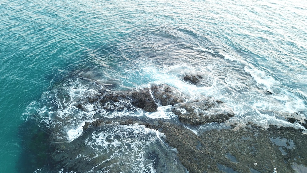 ocean waves crashing on shore during daytime