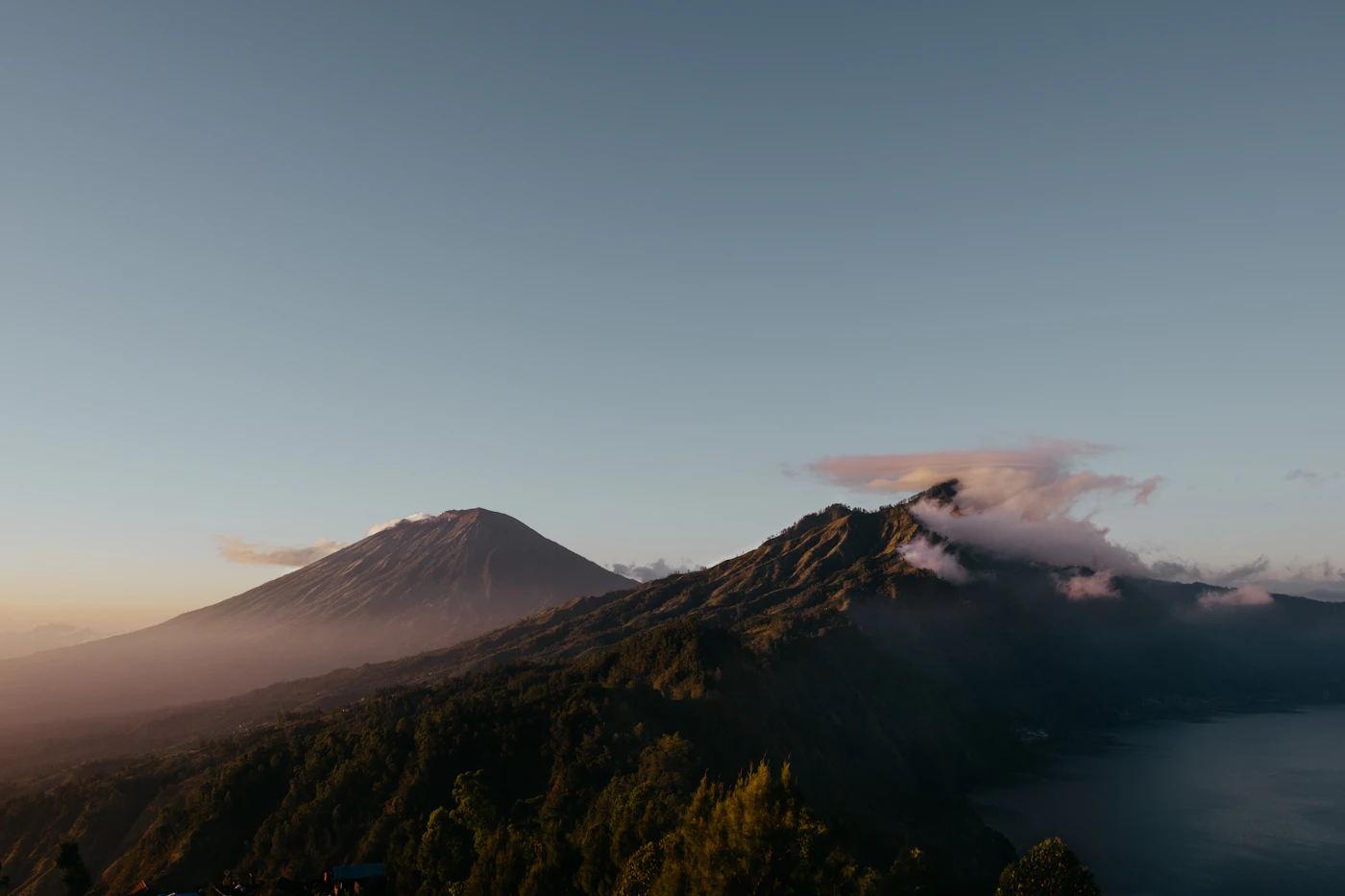 Mountain ridges of Bali under a soft dawn sky