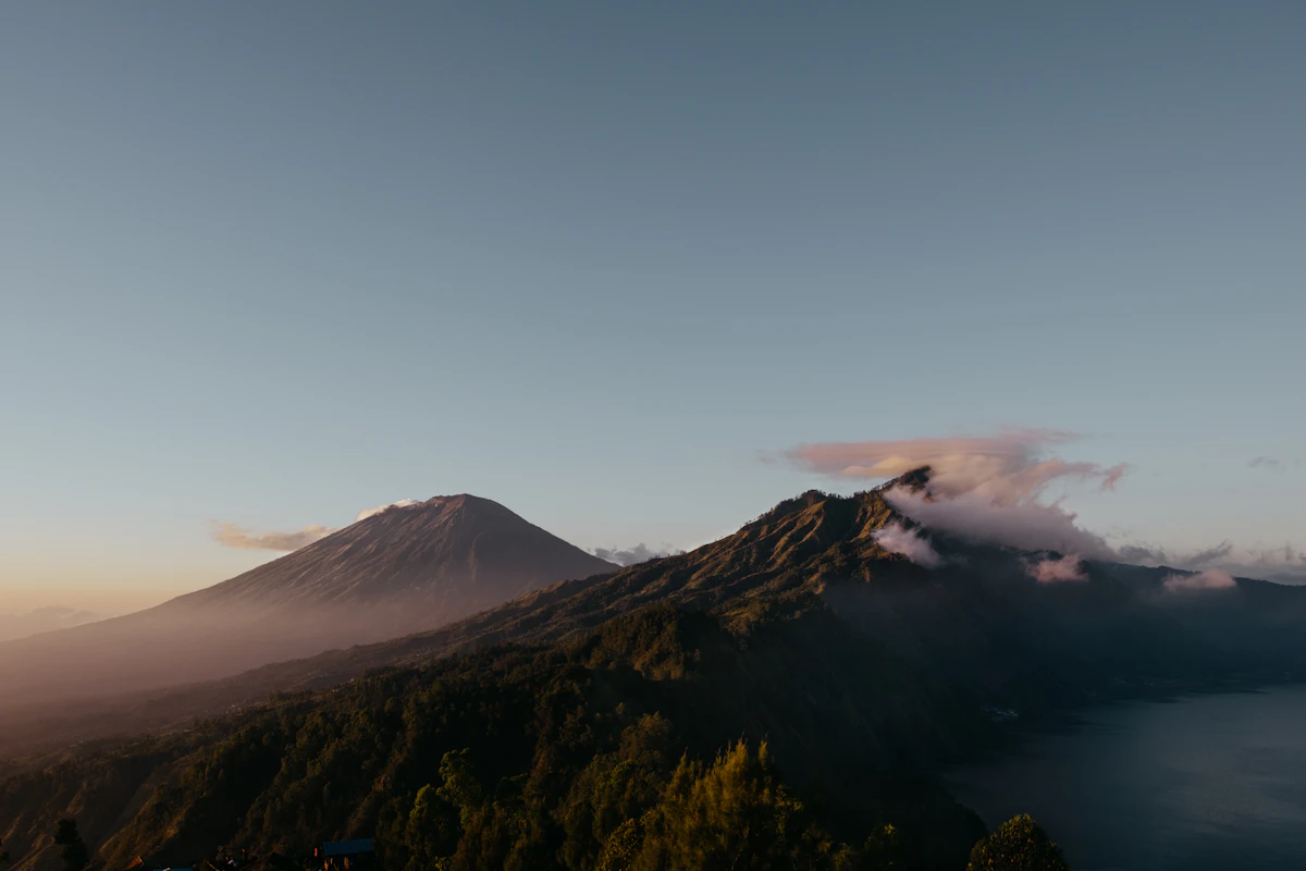 Dawn breaking above the cloud inversion at the 3,142-meter volcanic summit of Mount Agung