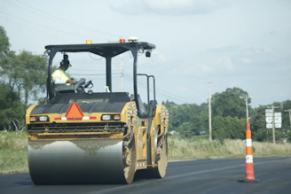 yellow and black heavy equipment on road during daytime