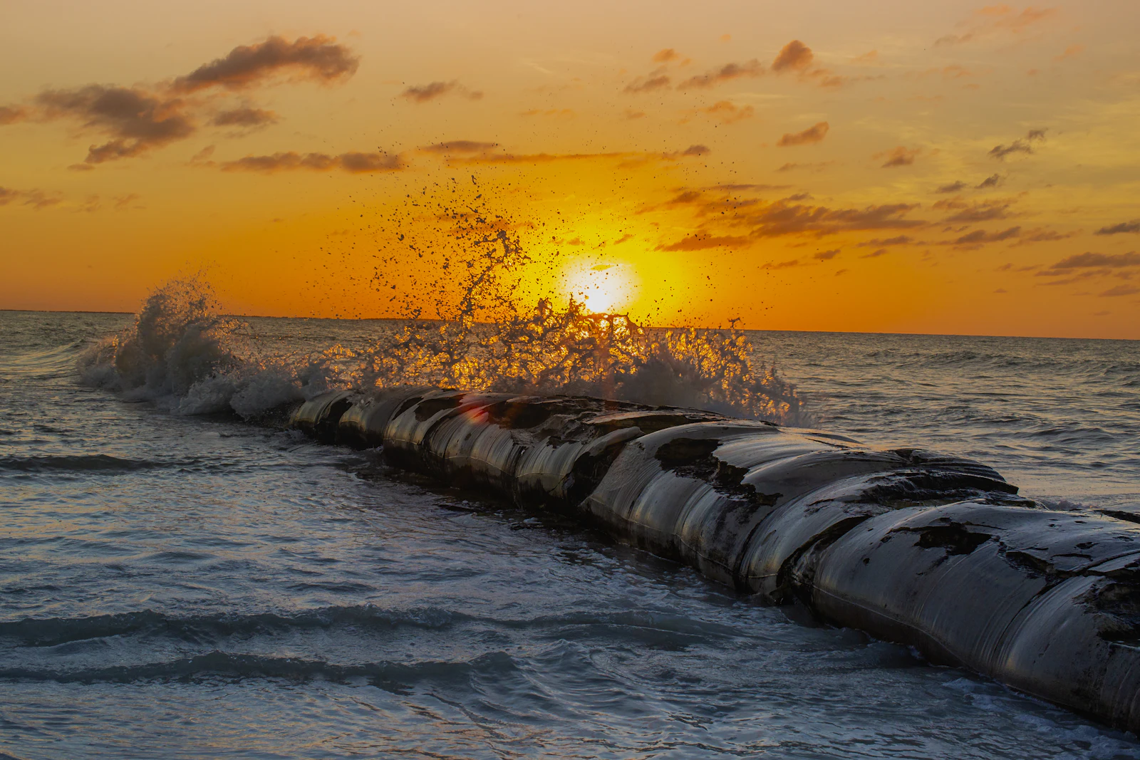 A wooden dock at sunset