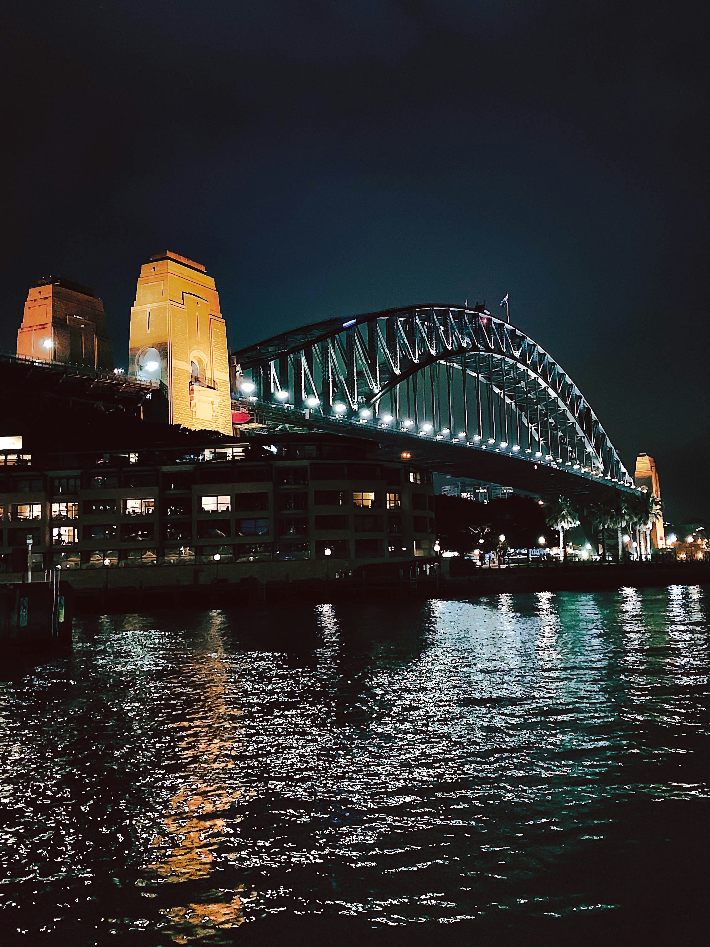 white and brown concrete building near body of water during night time