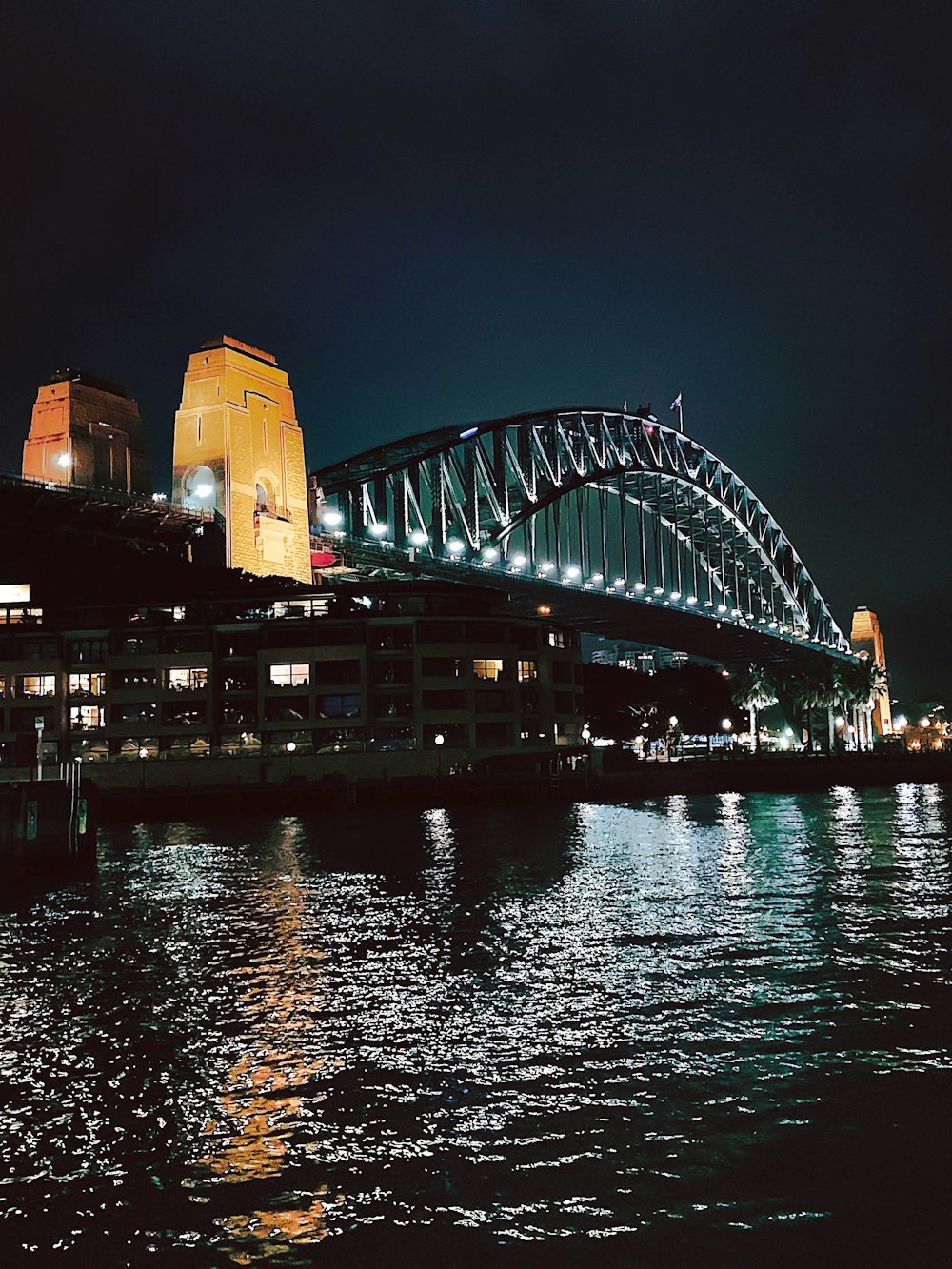 white and brown concrete building near body of water during night time