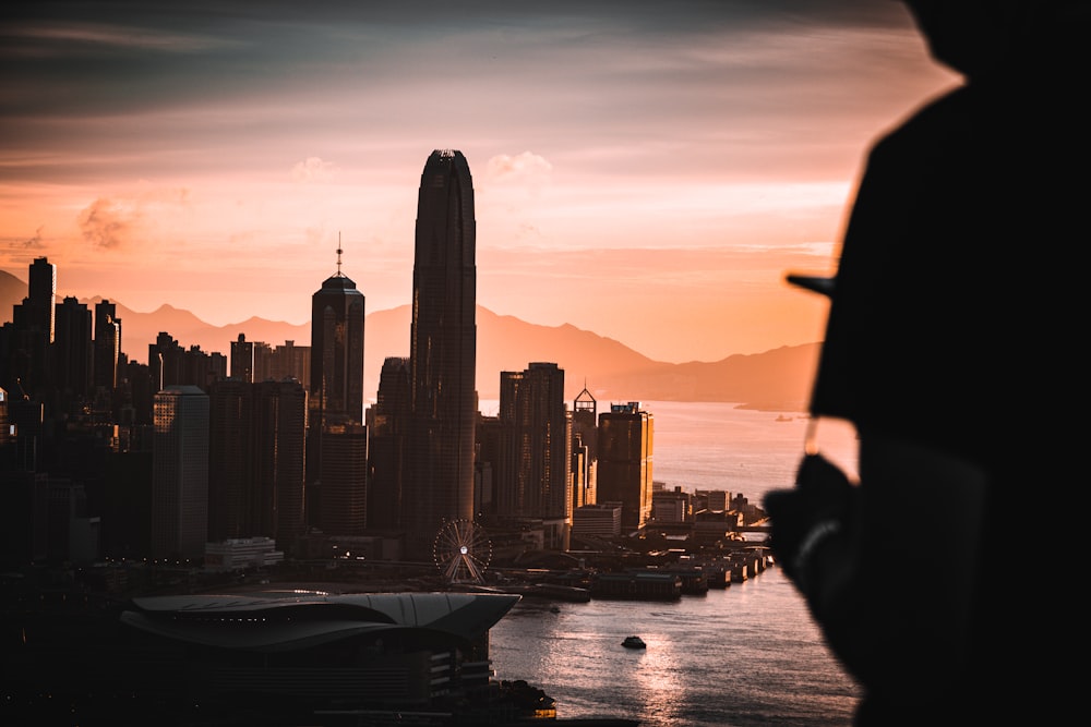 silhouette of person sitting on boat during sunset