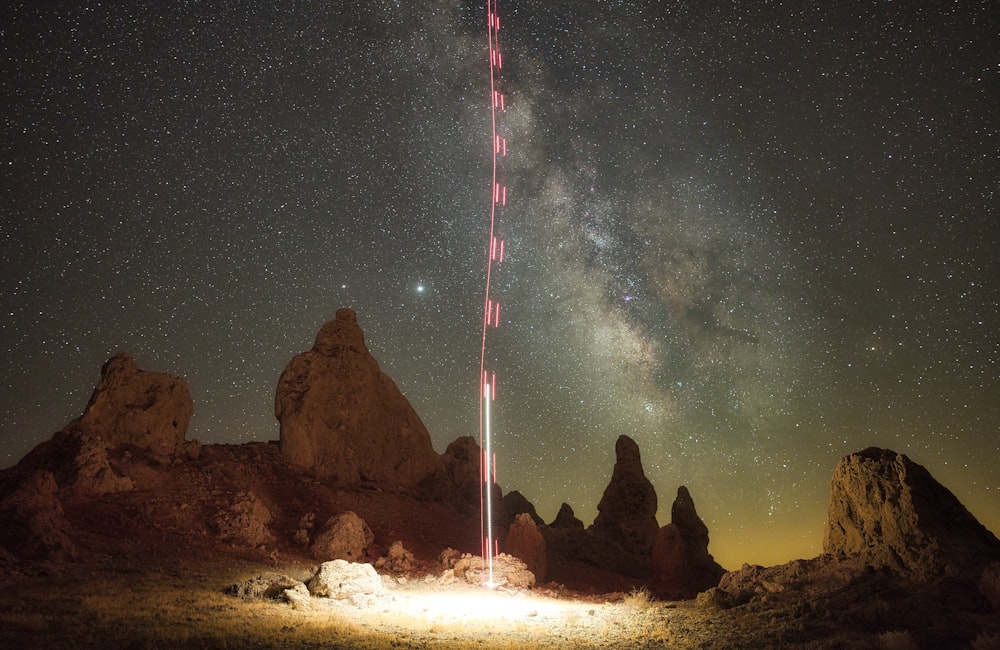 brown rock formation under starry night