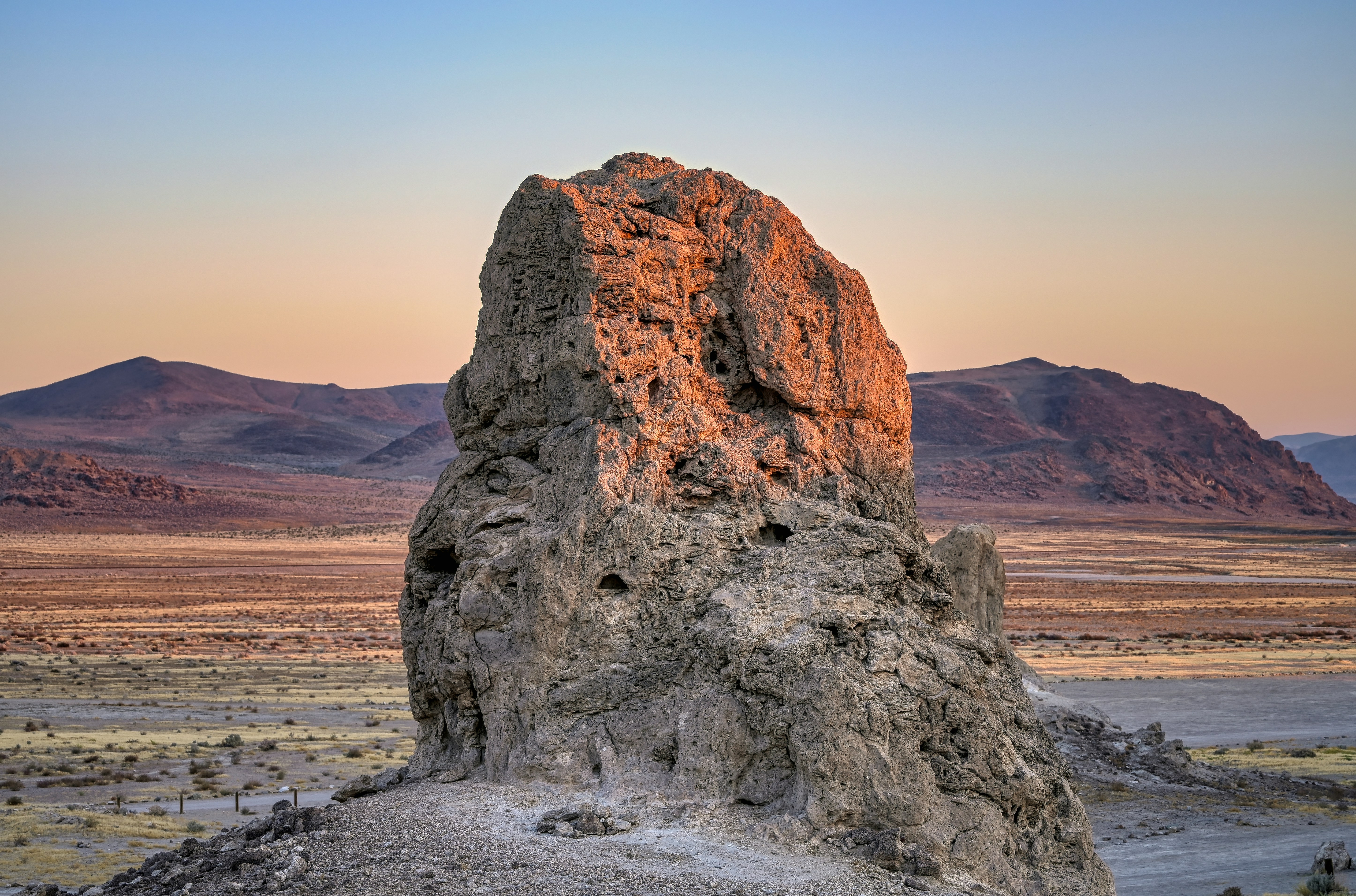 brown rock formation on brown field during daytime