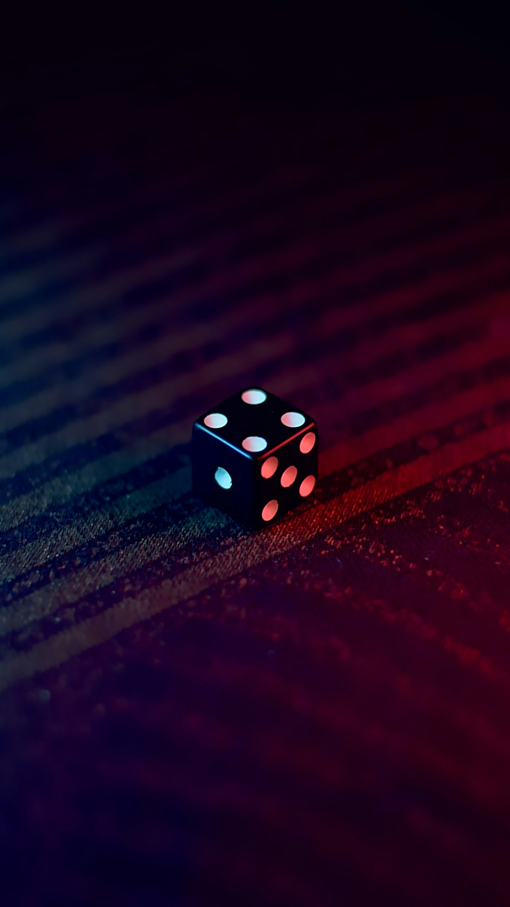 white and black dice on red textile
