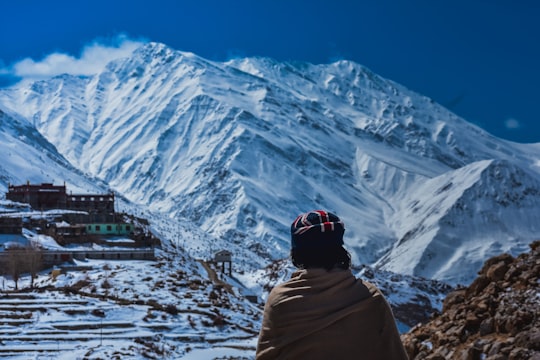 person in white hoodie standing on snow covered ground during daytime in Nako India