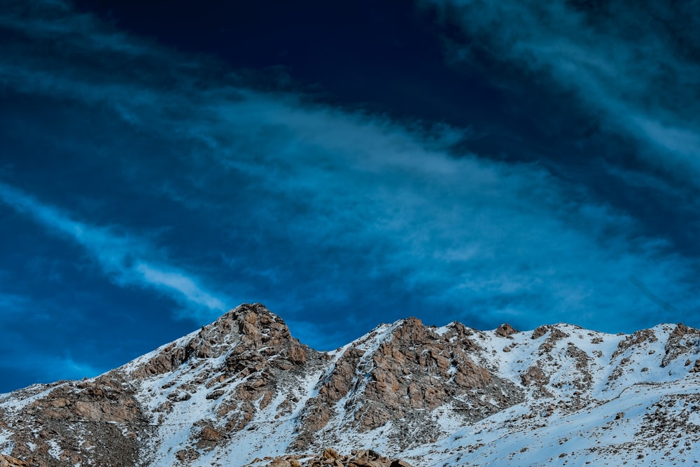 snow covered mountain under blue sky