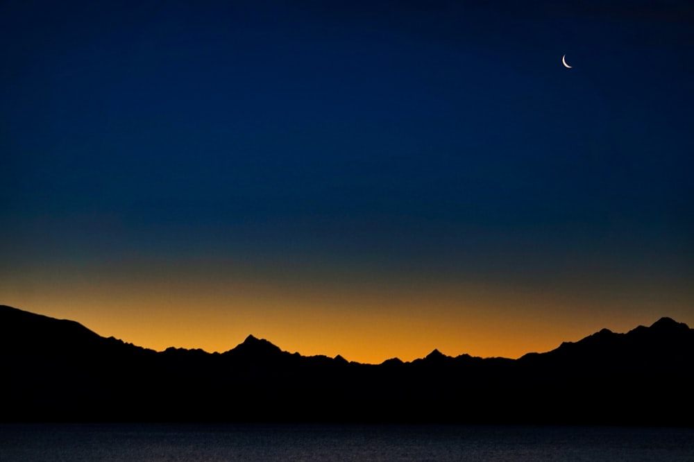 silhouette of mountain during sunset