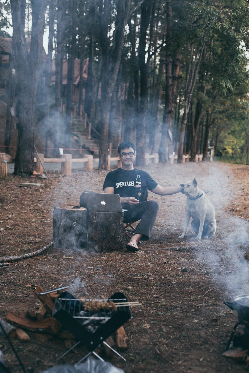 man in black crew neck t-shirt sitting on black plastic chair