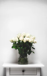 white flowers in clear glass vase