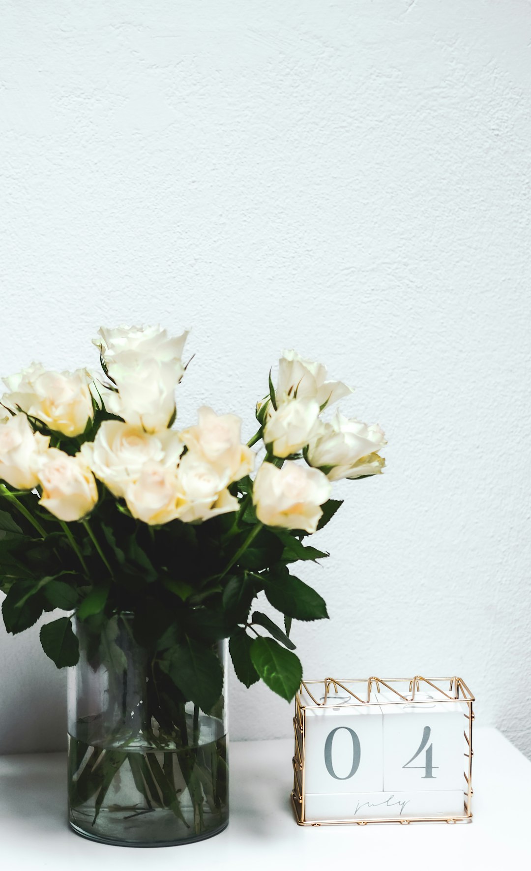 white flowers on white ceramic vase