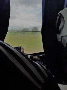 A customer choosing curtains inside their car with a mobile curtain sample service.