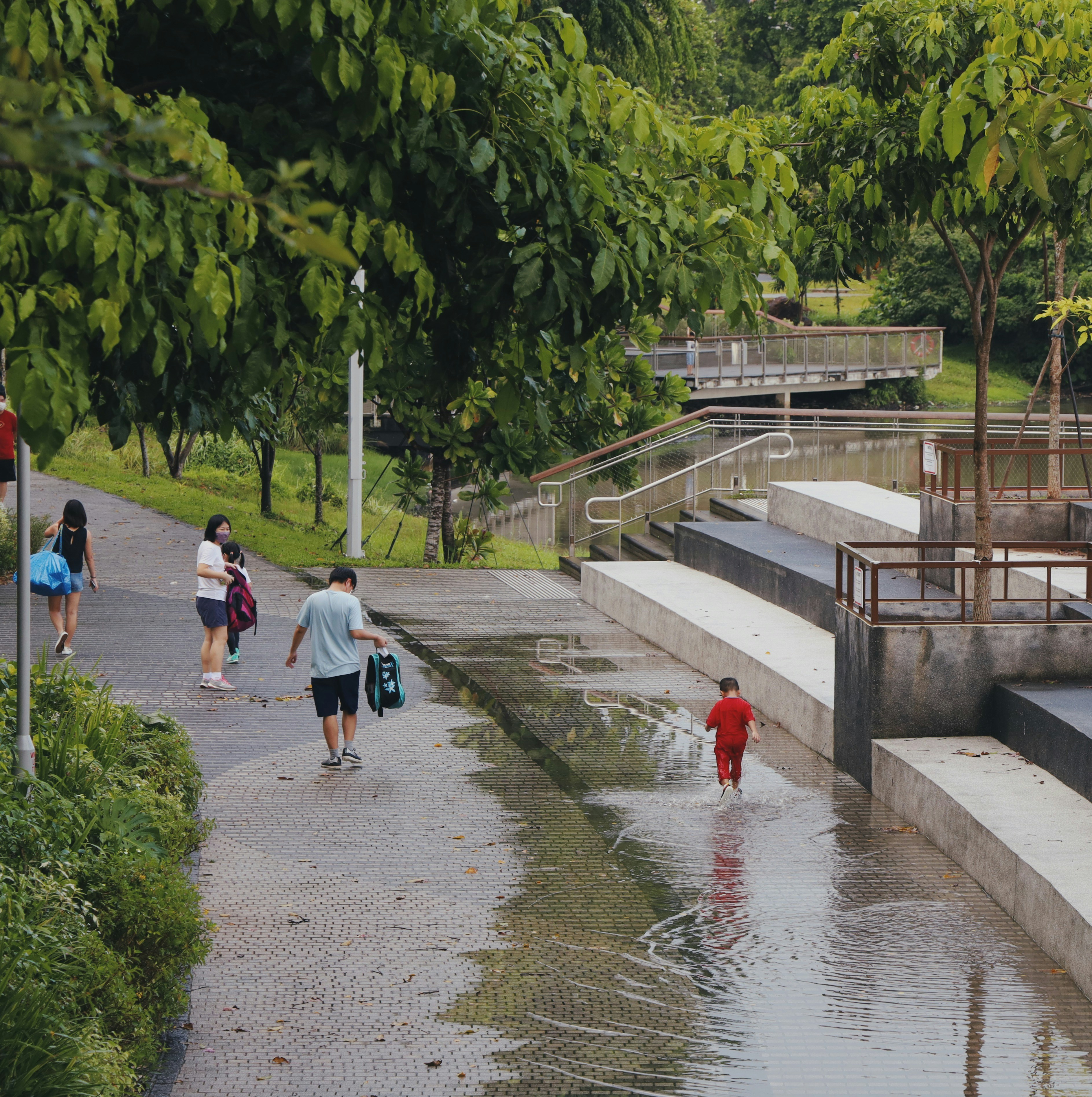 people walking on gray concrete bridge during daytime