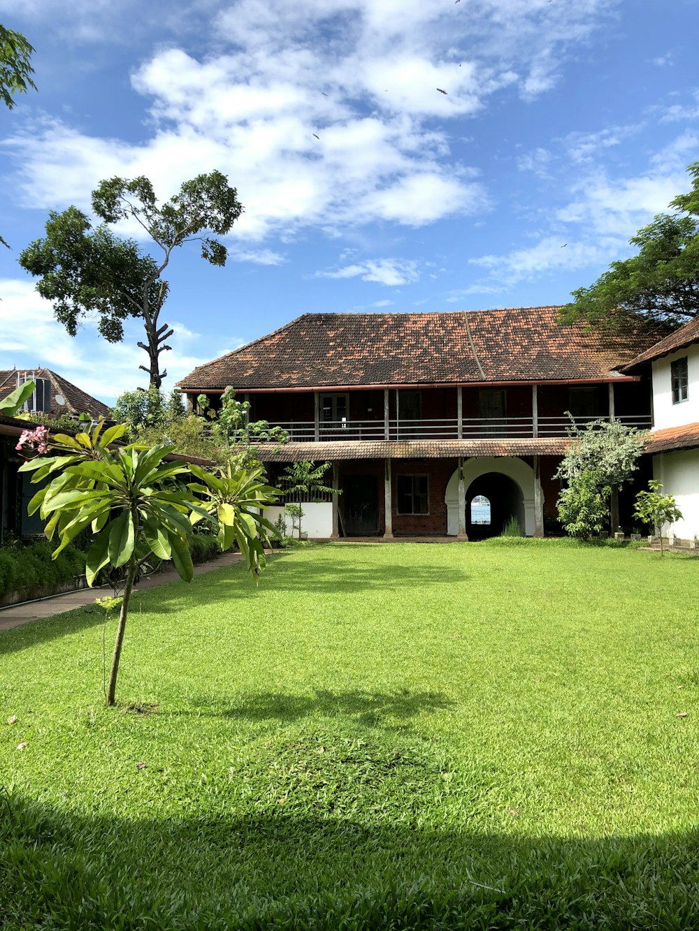 brown wooden house near green grass field during daytime