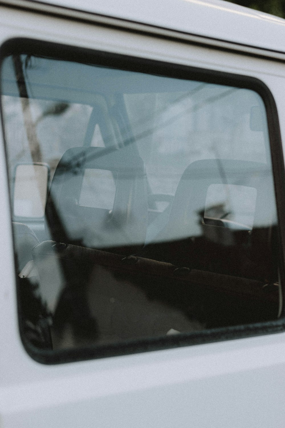 black car side mirror reflecting man in black shirt