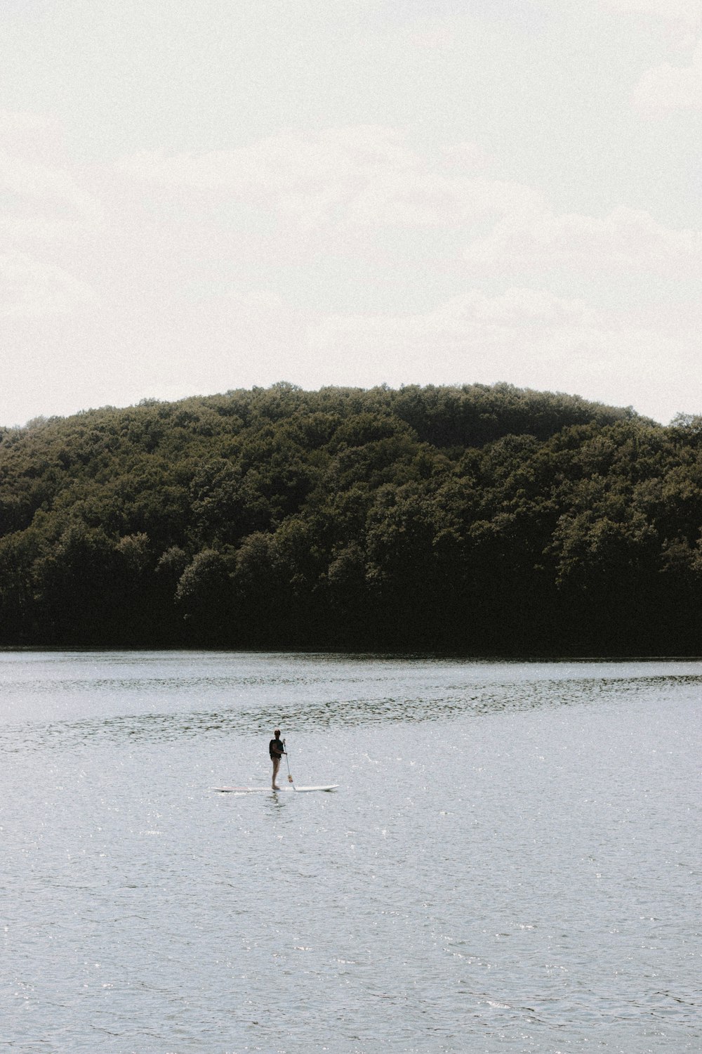 woman in white dress walking on water during daytime