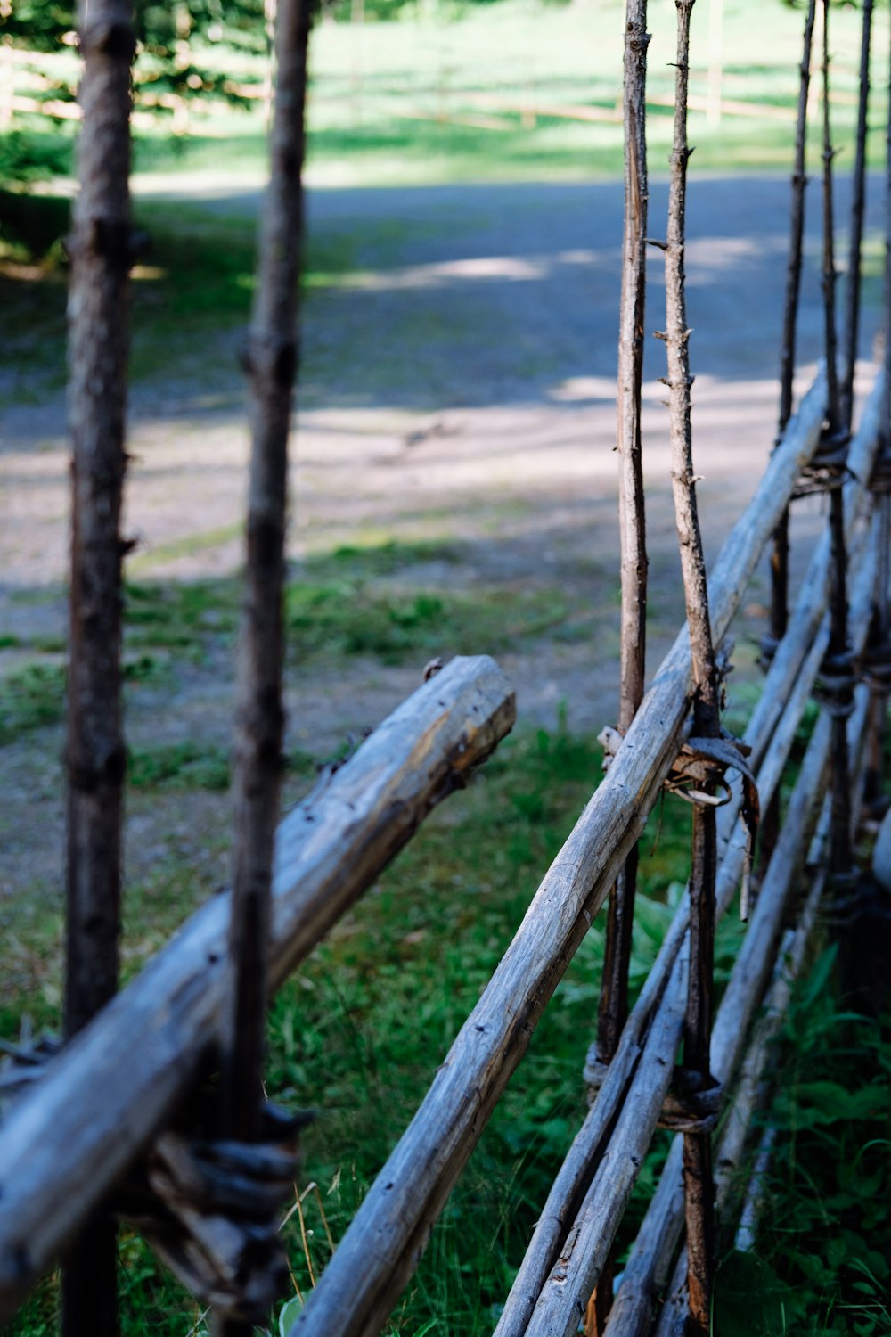 brown wooden fence near green grass field during daytime