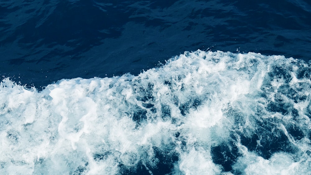 water waves on blue body of water during daytime