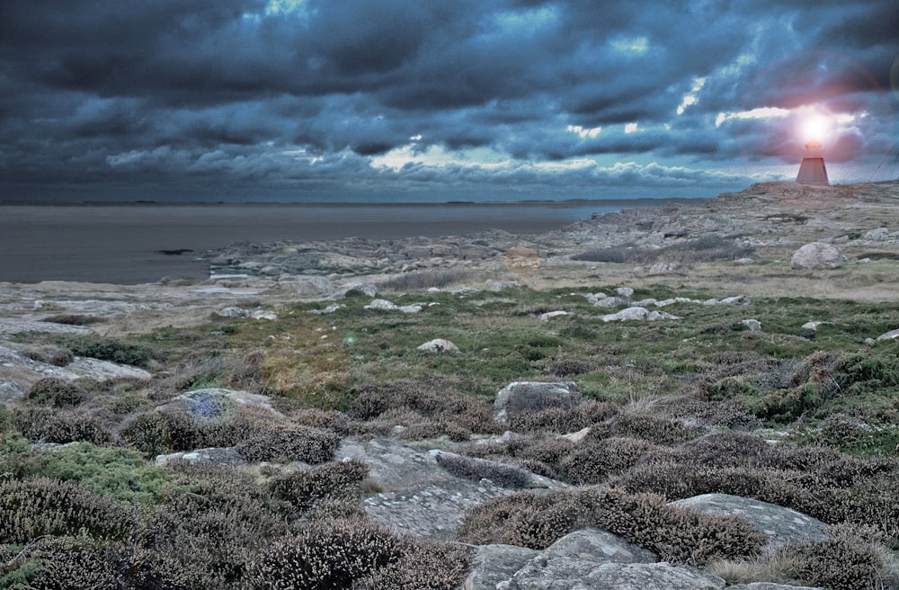 sea waves crashing on shore under cloudy sky during daytime