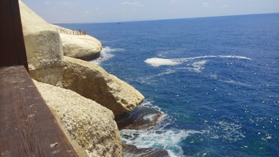 brown rock formation near body of water during daytime palestine zoom background